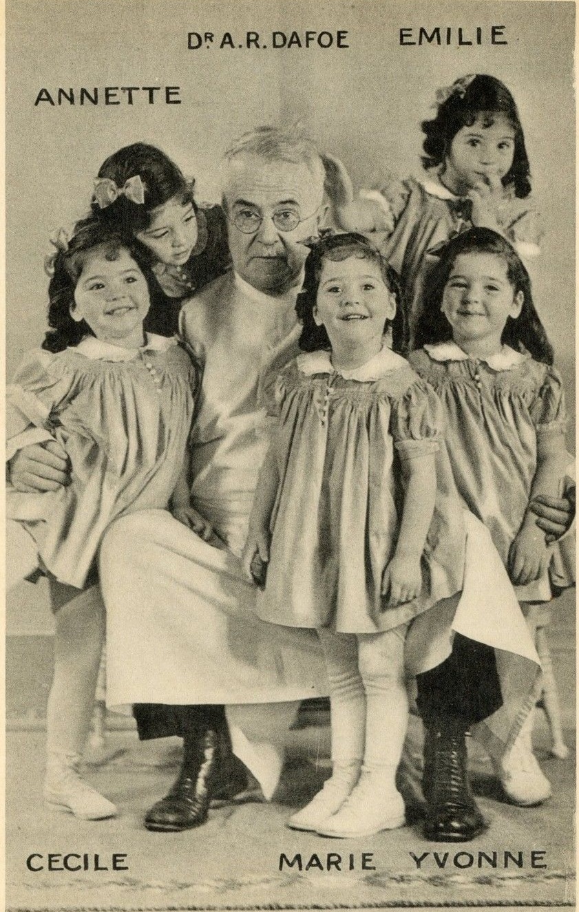 The five Dionne Quintuplets posed with the doctor who delivered them.