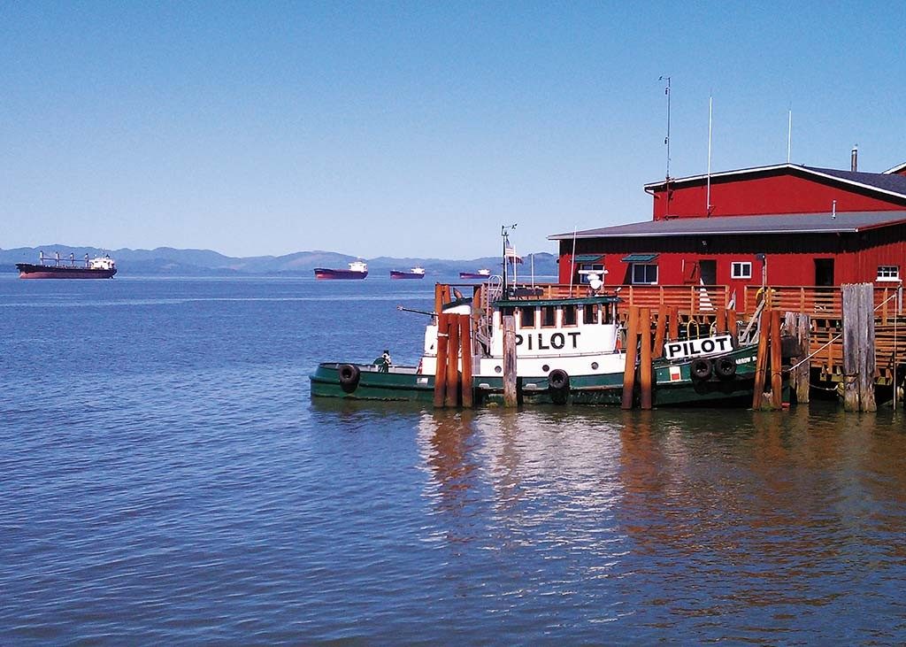 A tugboat docked at the Astoria waterfront.