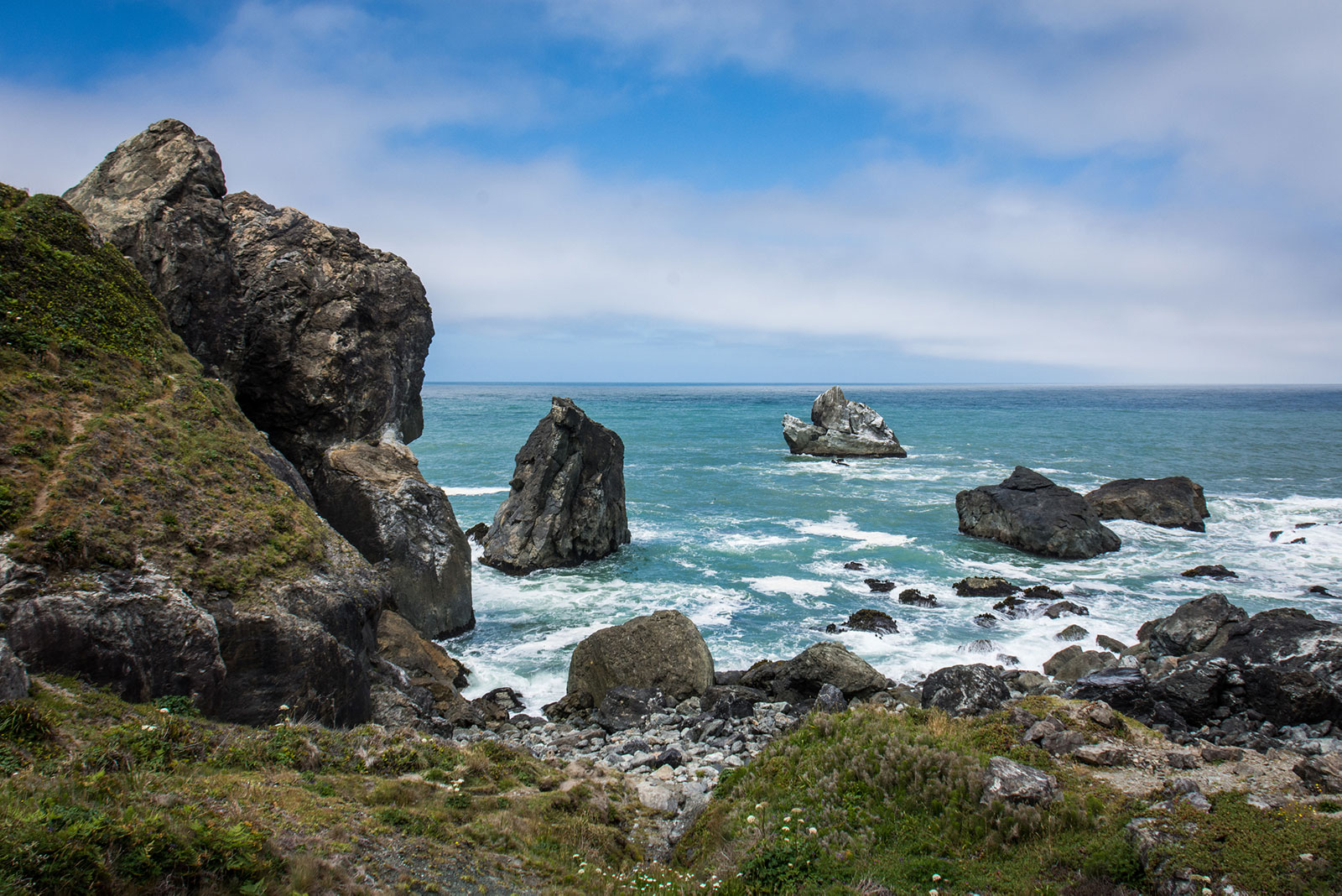 Waves crash against rocks at the shoreline of Patrick's Point State Park in Northern California